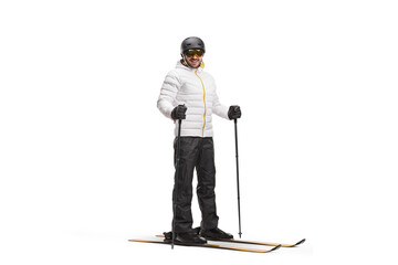 Full length portrait of a man with skis and a skiing pole