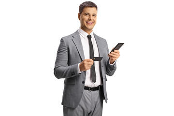 Young professional man using a smartphone and a credit card