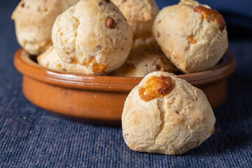 Close up of chipa, typical Paraguayan cheese bread on blue tablecloth.