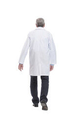 Senior doctor with stethoscope walking on white background