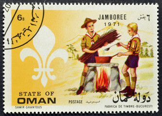 Cancelled postage stamp printed by Oman, that shows Scouts, circa 1971.