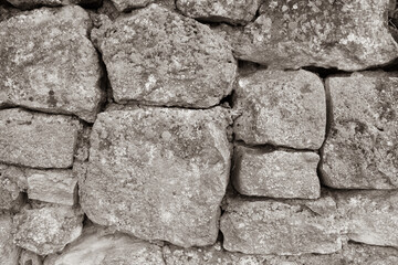 The art texture of old stonewall, close-up. Stone wall for backdrop design. Natural texture from big stones for publication, poster, calendar, post, screensaver, wallpaper, postcard, banner, website.