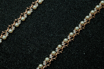 Fototapeta na wymiar Set of golden bracelet with diamonds over black background