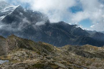 Panoramic view of Aiguille du Gouter with 2 flying paragliders