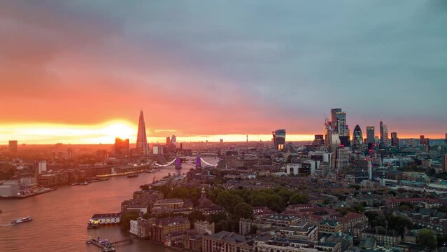 Cinematic Aerial Helicopter View Of Tower Bridge London City Skyline The Shard And Thames River Flying Through Clouds Hyper lapse Time Lapse View Of London Skyscraper UK, With A Beautiful Sunset 