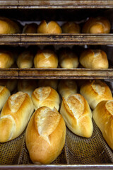French bread pouring out of the bakery oven
