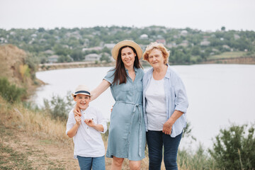 Mother with her son and grandma on vacation. Nice vacation in summer. Mother child at the lake	