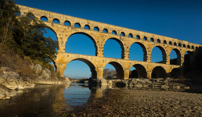 Fototapeta premium Image of famous landmark Roman Bridge Pont du Gard in southern France..