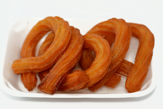 Turkish Churros, very popular street foods or street desserts in Turkey, Halka Tatlisi circular dessert fried in oil and sweetened with honey syrup, selective focus of halka tatlisi Sweet Churros