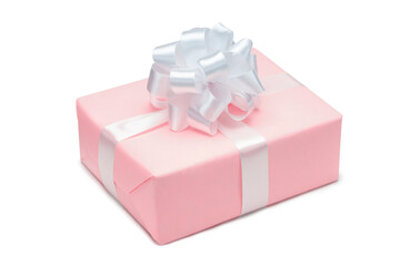 Close up shot of gift box wrapped in pastel pink paper and decorated with white satin ribbon bow, isolated on white background