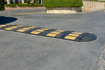 Lying policeman. Overhead plastic speed bump police cars on the road.