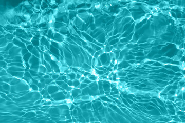 Defocus blurred transparent blue colored clear calm water surface texture with splashes and...