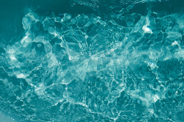 Defocus blurred transparent blue colored clear calm water surface texture with splashes and bubbles. Trendy abstract nature background. Water waves in sunlight with copy space. Blue watercolor shining