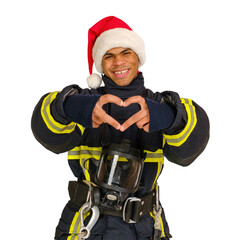 Young smiling African-American fireman in uniform and red Santa Hat showing heart sign with fingers...