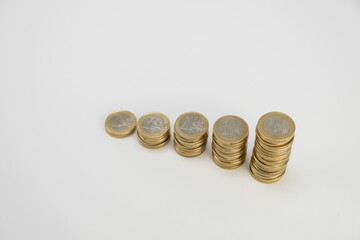 One Euro Coins stacked on a white background. Top view perspective. Money coins saving concept side...