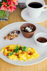 Breakfast with egg, coffee and sauce.
