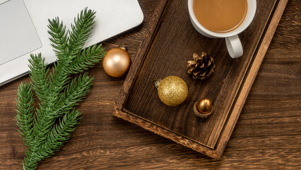 Christmas background with Laptop, coffee, fir branches, decorations.