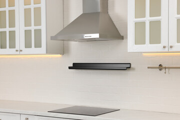 Modern range hood and furniture in kitchen