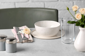 Fototapeta na wymiar Beautiful table setting with fabric napkin and roses indoors