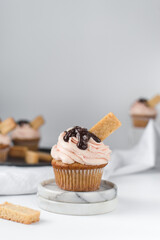 Vanilla cupcake with pink frosting, plain cupcake with pastel pink buttercream