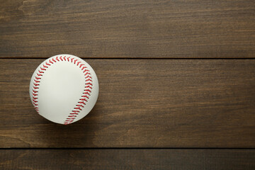 Baseball ball on wooden table, top view. Space for text