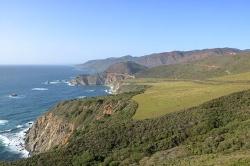 The rugged Big Sur coastline on the Central Coast of California with the famous Bixby Bridge in the distance