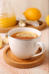 Tea, honey, lemon and ginger on beige textured table