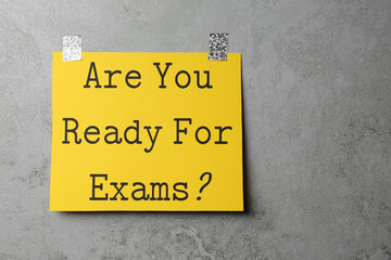 Sheet of paper with question Are You Ready For Exams? on grey table, top view