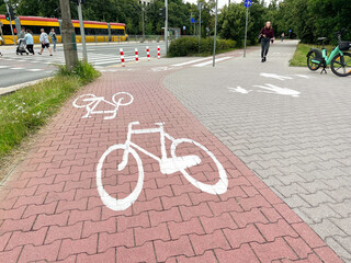 Street with road, pedestrian zone and red paved bicycle lane