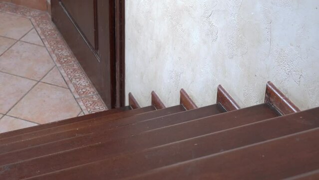 Small soccer ball is flying down the stairs, view from above. Children or pet were playing and missed the toy, but it is dangerous for them to go down the stairs, so it is forbidden.