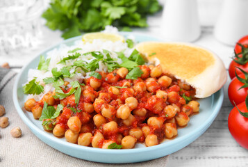 Plate with delicious chickpea curry on table, closeup