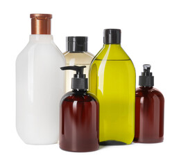 Different bottles of shampoo on white background