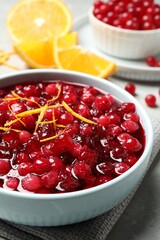 Fresh cranberry sauce with orange peel in bowl, closeup