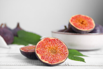 Fresh ripe figs on white wooden table, closeup