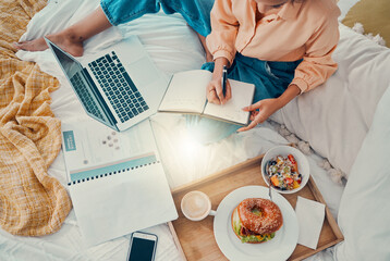 Marketing, laptop and woman writing with breakfast on her bed, working and planning information for...