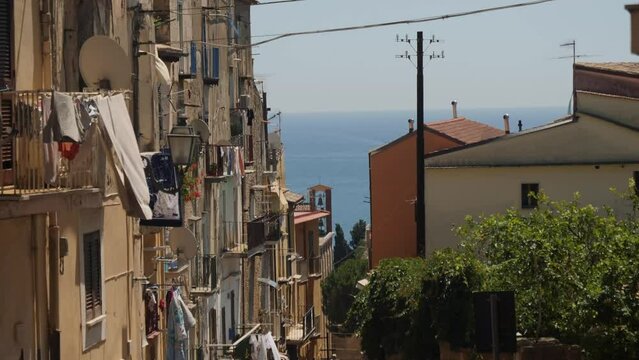 Laundry drying on balconies of Formia city with majestic view to seascape, handheld view
