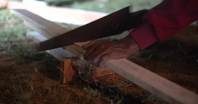 cutting wood block with hand saw old style indian hand saw for wood cutting at night indina