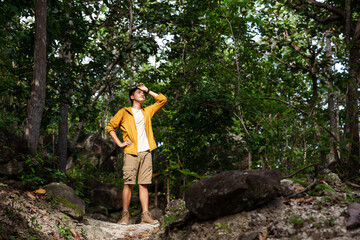 Asian teenager hike through forest to peak of mountain, Admiring nature, relaxing.