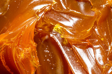 Close up of orange colored industrial grease. Rich and thick texture of industrial grade grease...