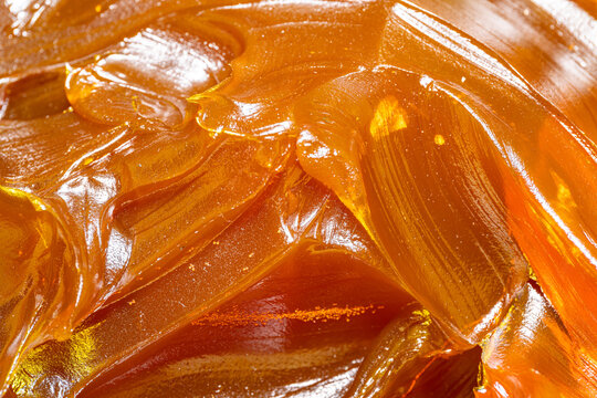 Close up of orange colored industrial grease. Rich and thick texture of industrial grade grease used to smooth out all metal friction. Lubricating grease. close-up of yellow lithium grease for machine
