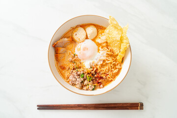 instant noodles with pork and meatballs in spicy soup
