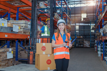 Portrait asian engineer in helmets order on tablet for checking goods and supplies on shelves with goods background in warehouse.logistic  business export ,Warehouse worker checking packages on store.