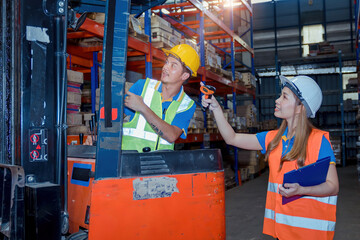 Portrait asian engineer in helmets order on tablet for checking goods and supplies on shelves with goods background in warehouse.logistic  business export ,Warehouse worker checking packages on store