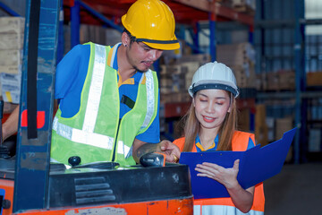 Portrait asian engineer in helmets order on tablet for checking goods and supplies on shelves with goods background in warehouse.logistic  business export ,Warehouse worker checking packages on store