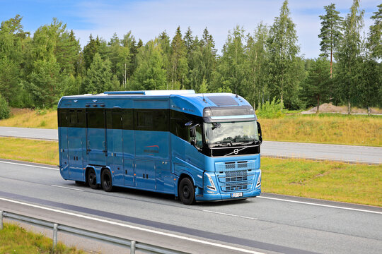 New, blue Volvo FH horsebox truck for transporting sports horses at speed on motorway in South of Finland.