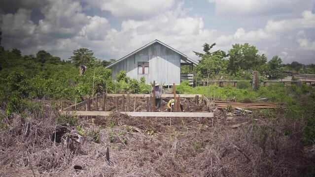 KALIMANTA UTARA, INDONESIA - NOVEMBER 26 2019. workers build simple houses for transmigration residents