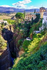 Fototapeta na wymiar Beautiful mountainous landscape of Andalusian houses on the hills formed by the gorge of the river, Ronda Malaga.