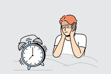 Guy in bed closes ears not to hear sounds in morning. Alarm clock is ringing. Getting up early for work, education. Sleeping man does not want to wake up. Vector linear colored isolated illustration.