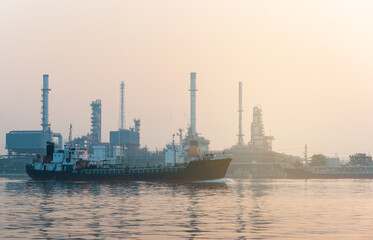 The oil tanker is loading at the oil refinery.