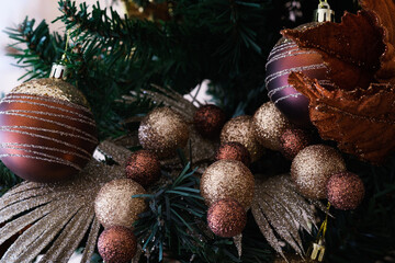 Close up of bauble balls on christmas tree. Green pie tree background. happy New Year holiday celebration concept.